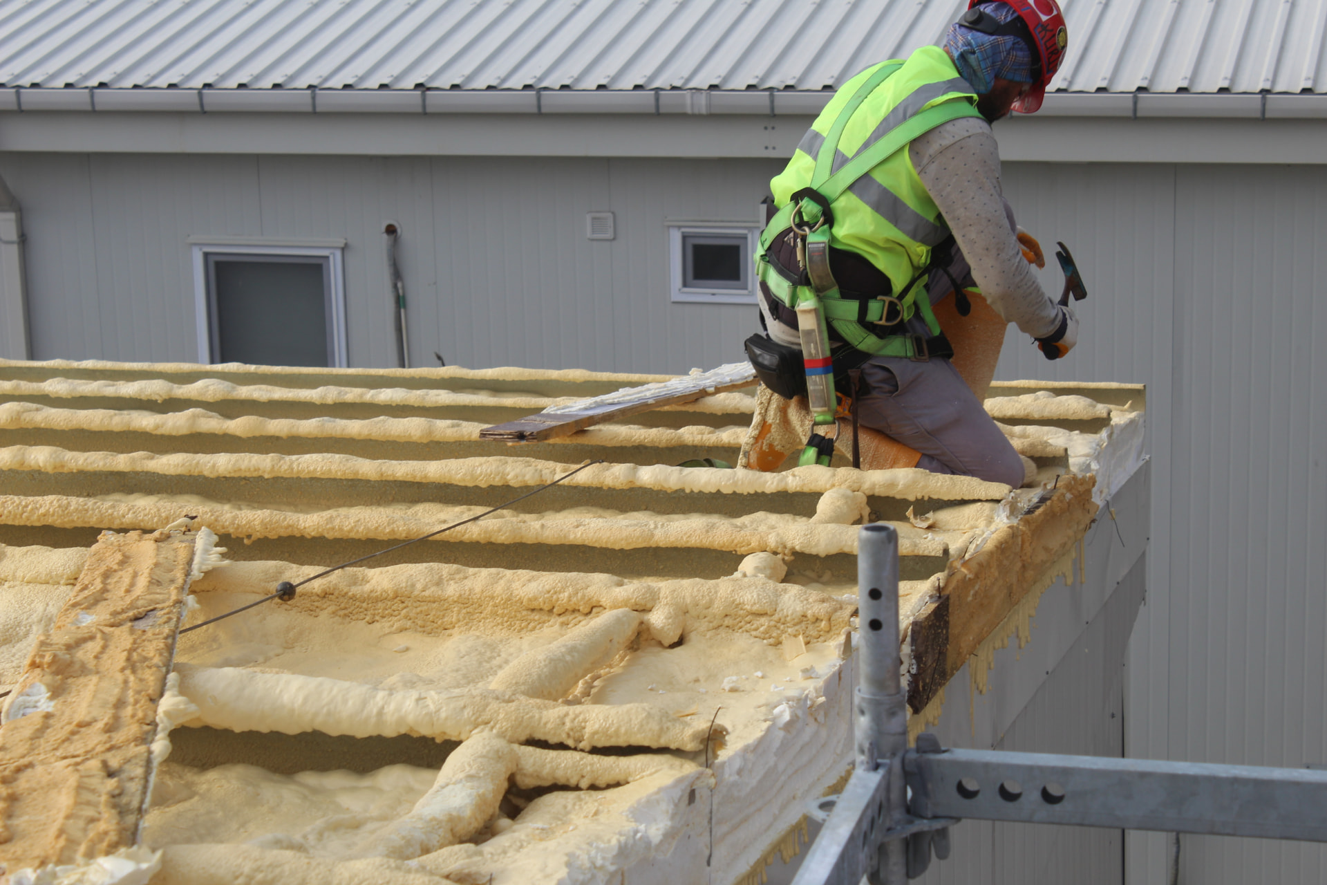Spray foam insulation being applied to a rooftop