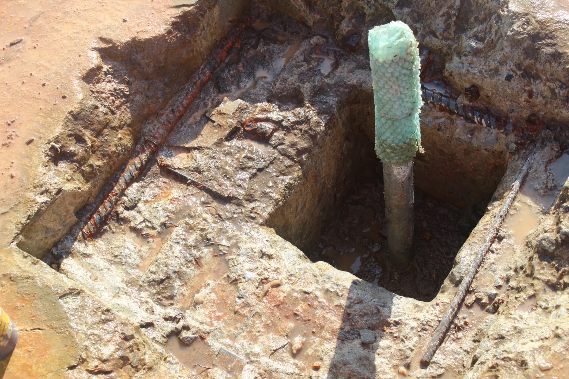 Close-up of an exposed anchor bolt pocket with reinforcement ready for grout