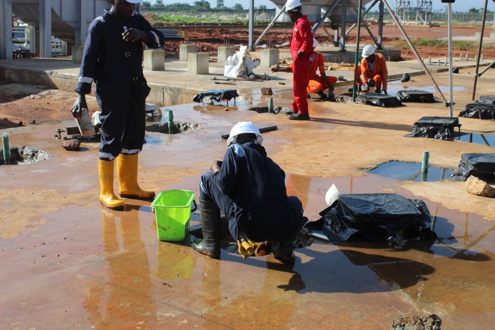 Site team mixing and placing non-shrink grout at anchor bolt locations