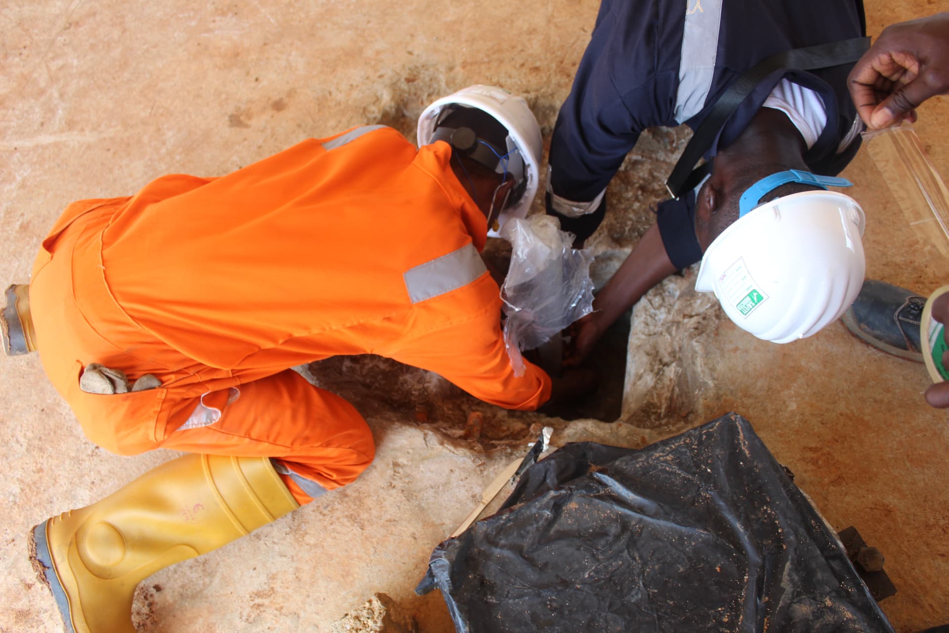 Technicians sealing an anchor bolt pocket ahead of grouting