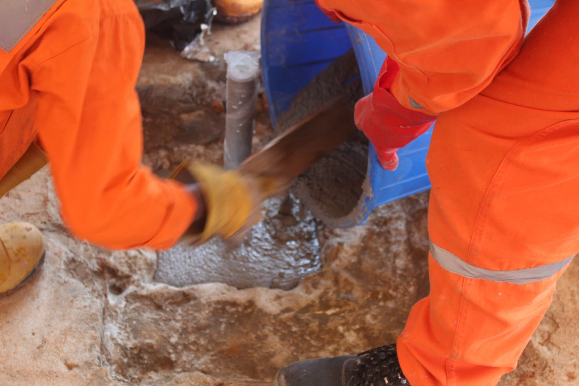 Placing non-shrink grout into a prepared foundation pocket