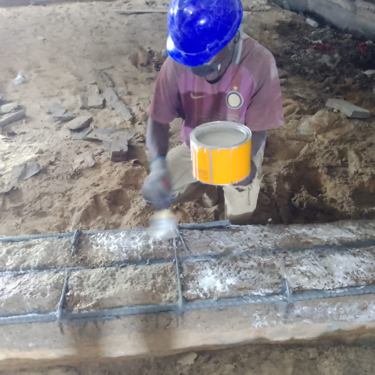 Bonding agent applied over exposed reinforcement before mortar placement