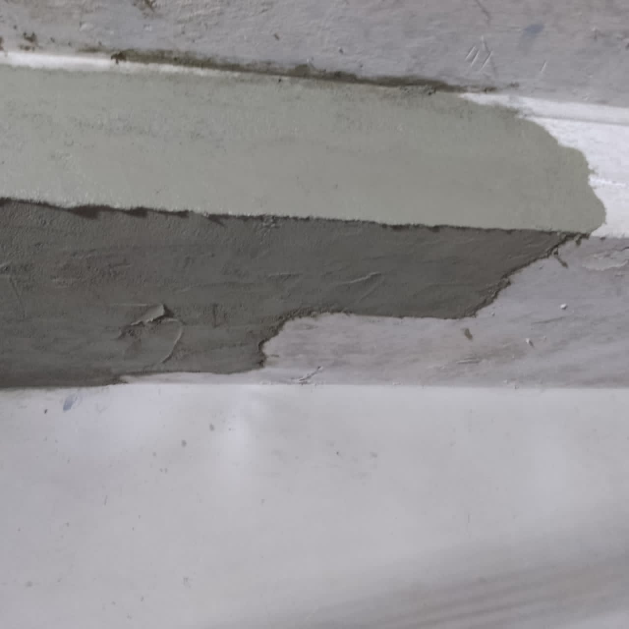 Repair mortar applied in layers along the basement beam soffit