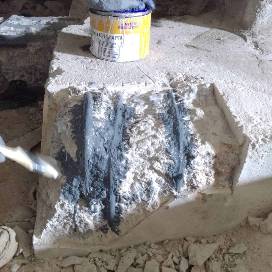Brushing bonding agent onto exposed reinforcement in a column base