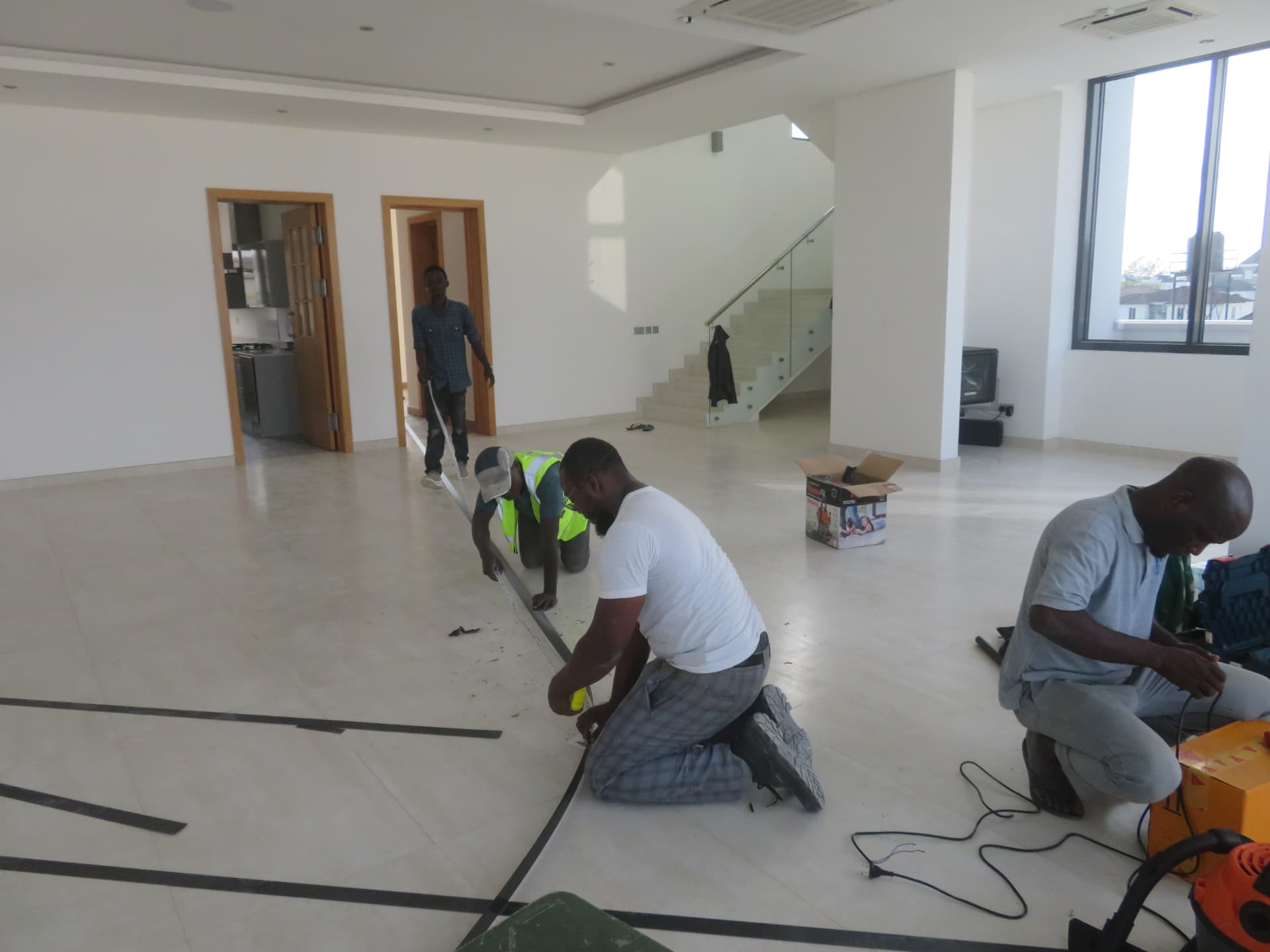 Setting out and measuring carbon laminate strips across the floor slab