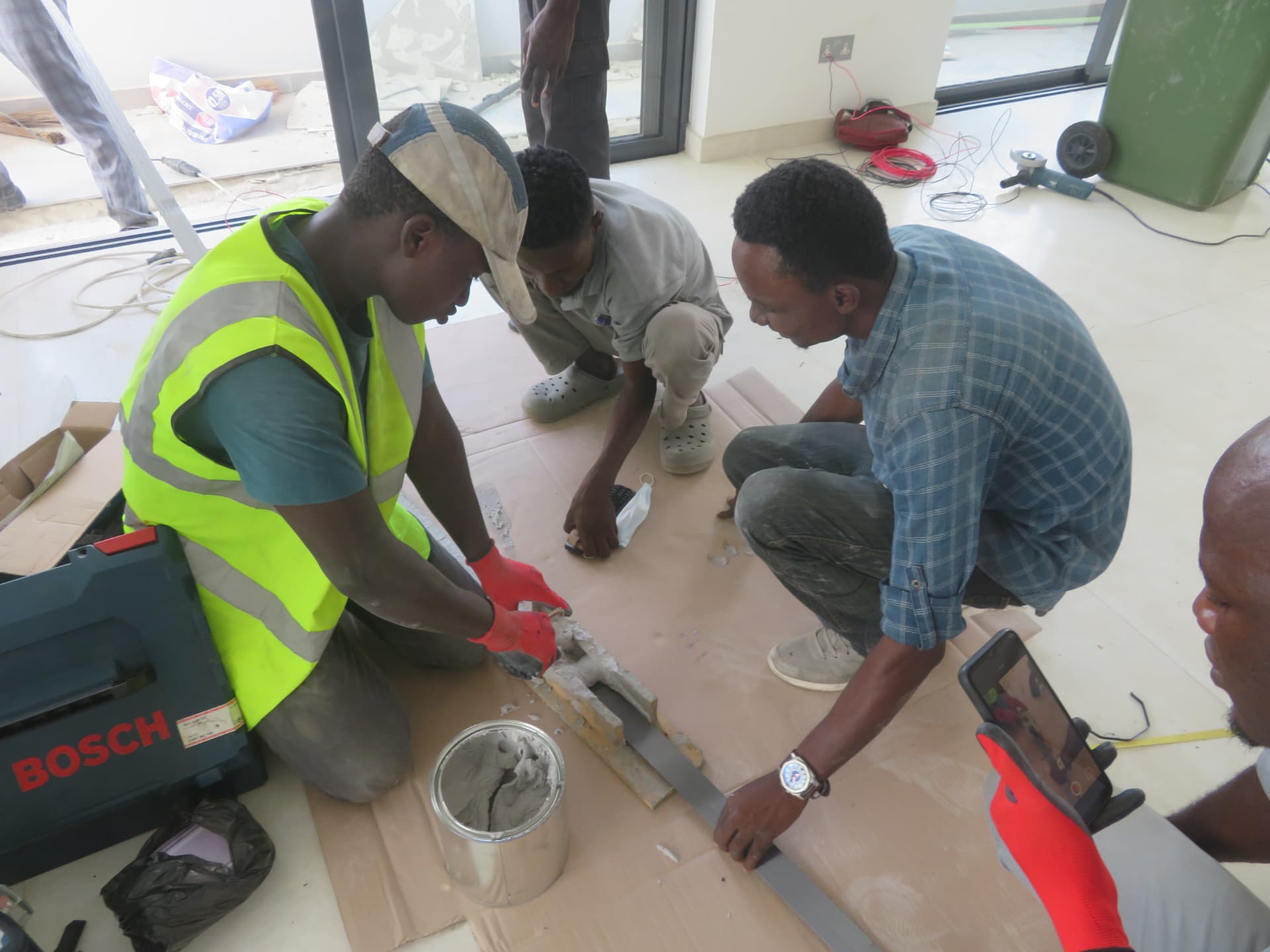 Team preparing two-component epoxy and bedding the carbon laminate