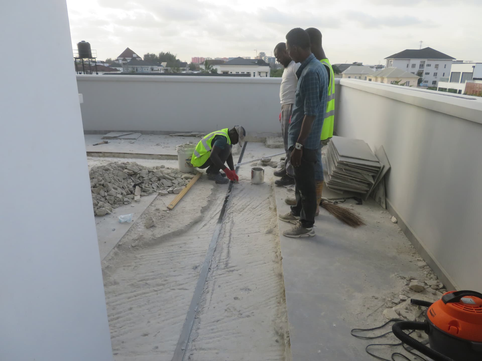Supervisors inspecting laminate bonding along the rooftop slab