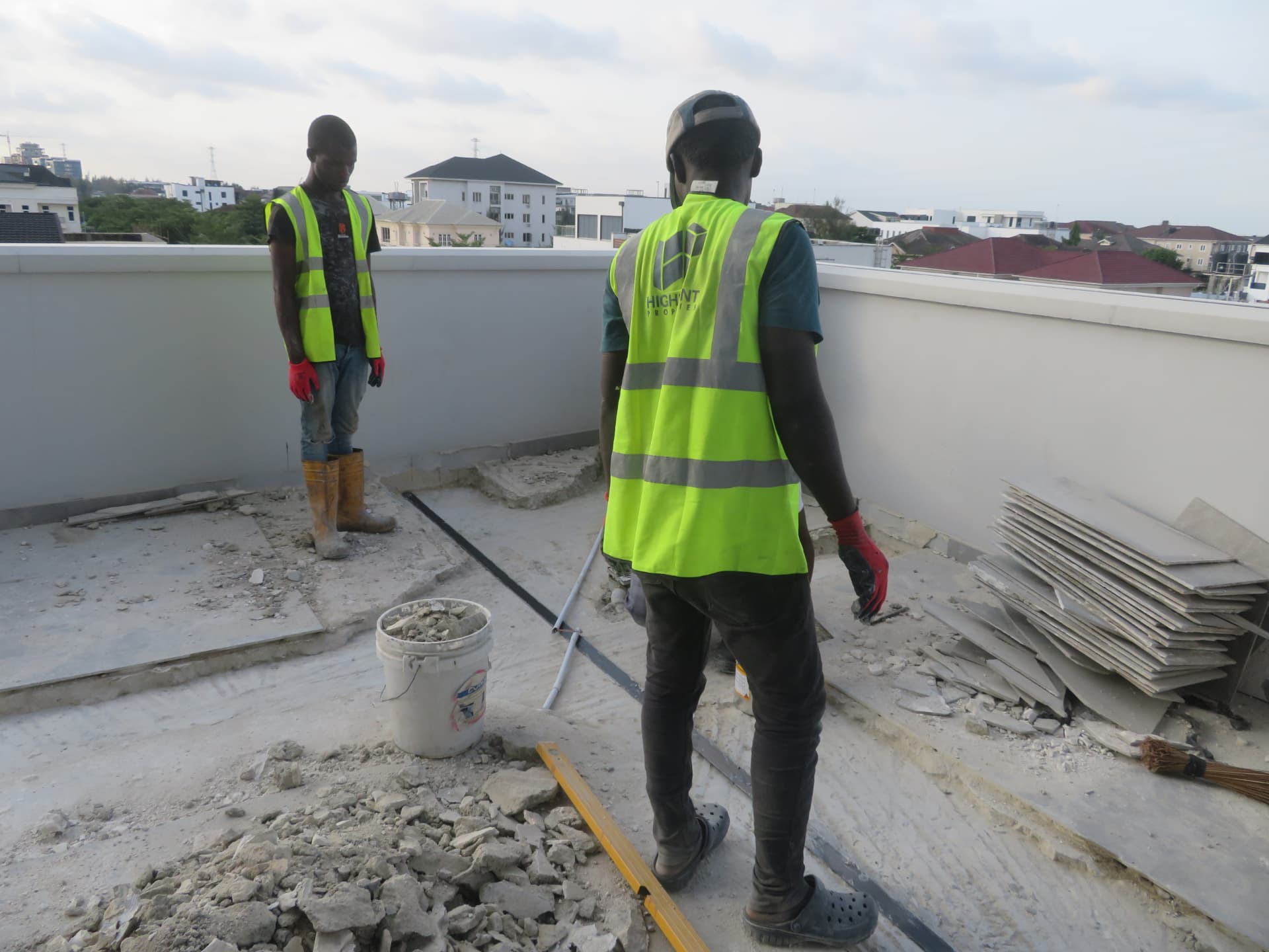 Site team reviewing laminate strip alignment on the terrace