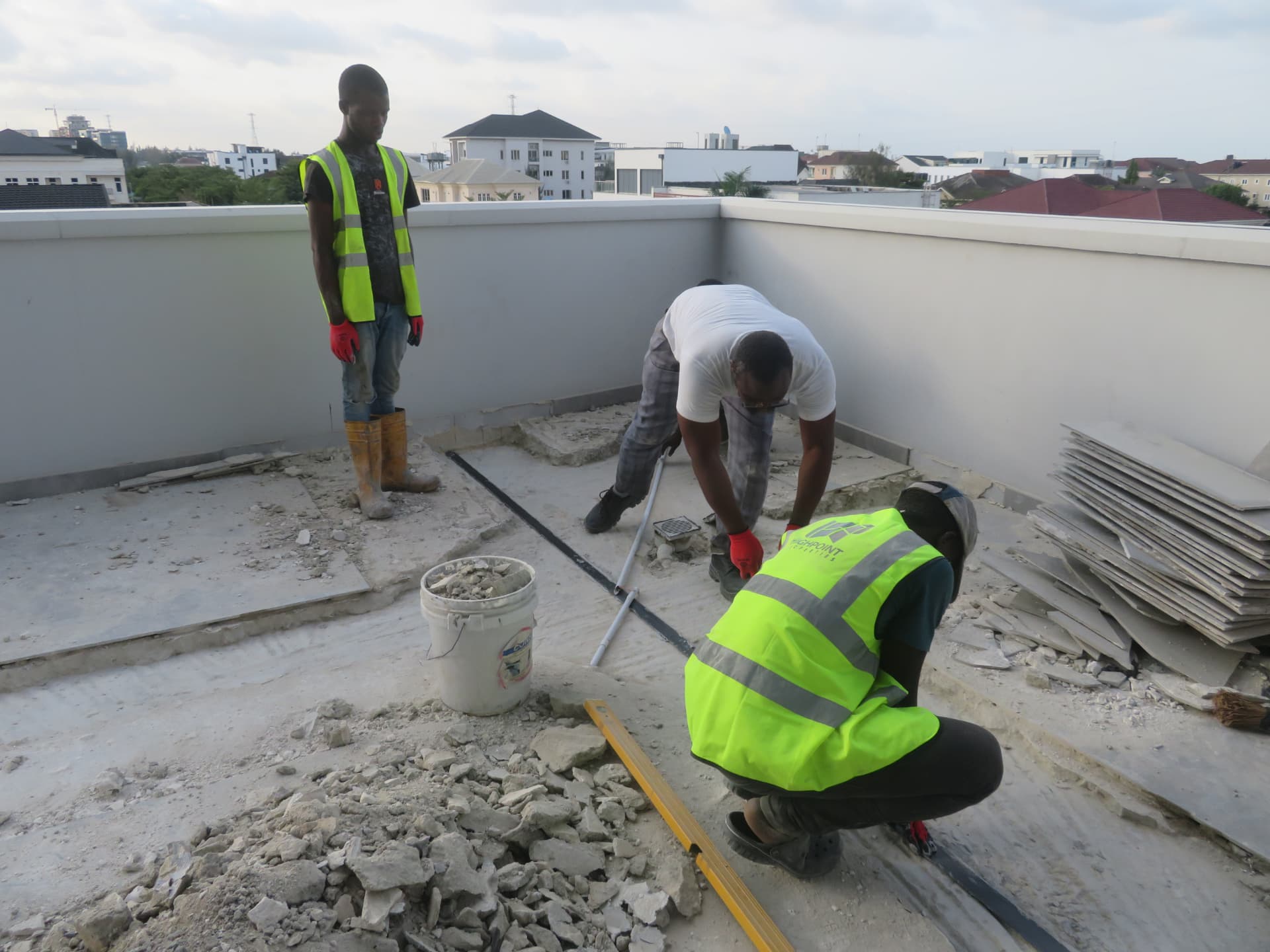 Crew cleaning and levelling the groove before laminate placement