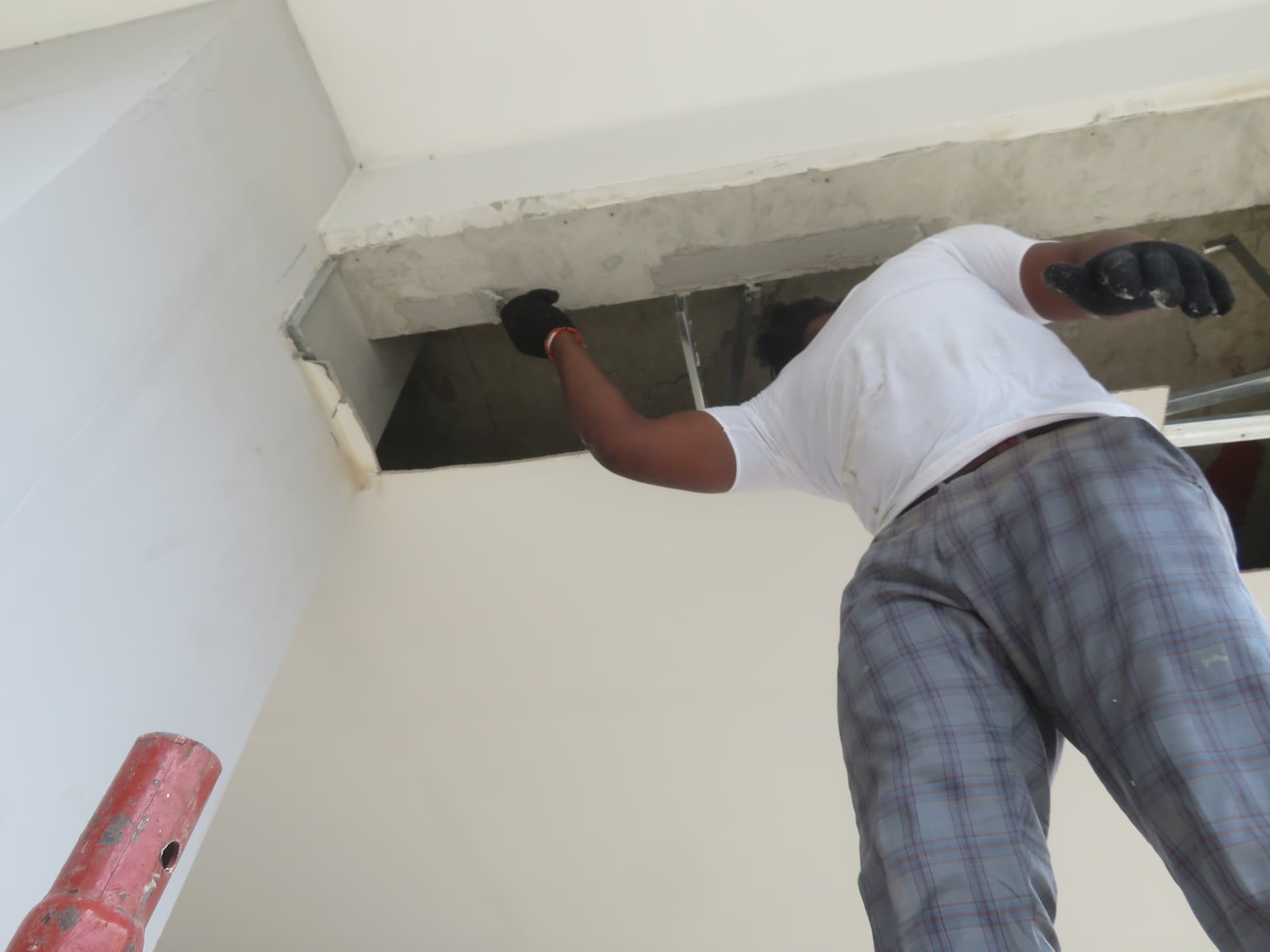 Technician installing carbon laminate to the underside of a beam