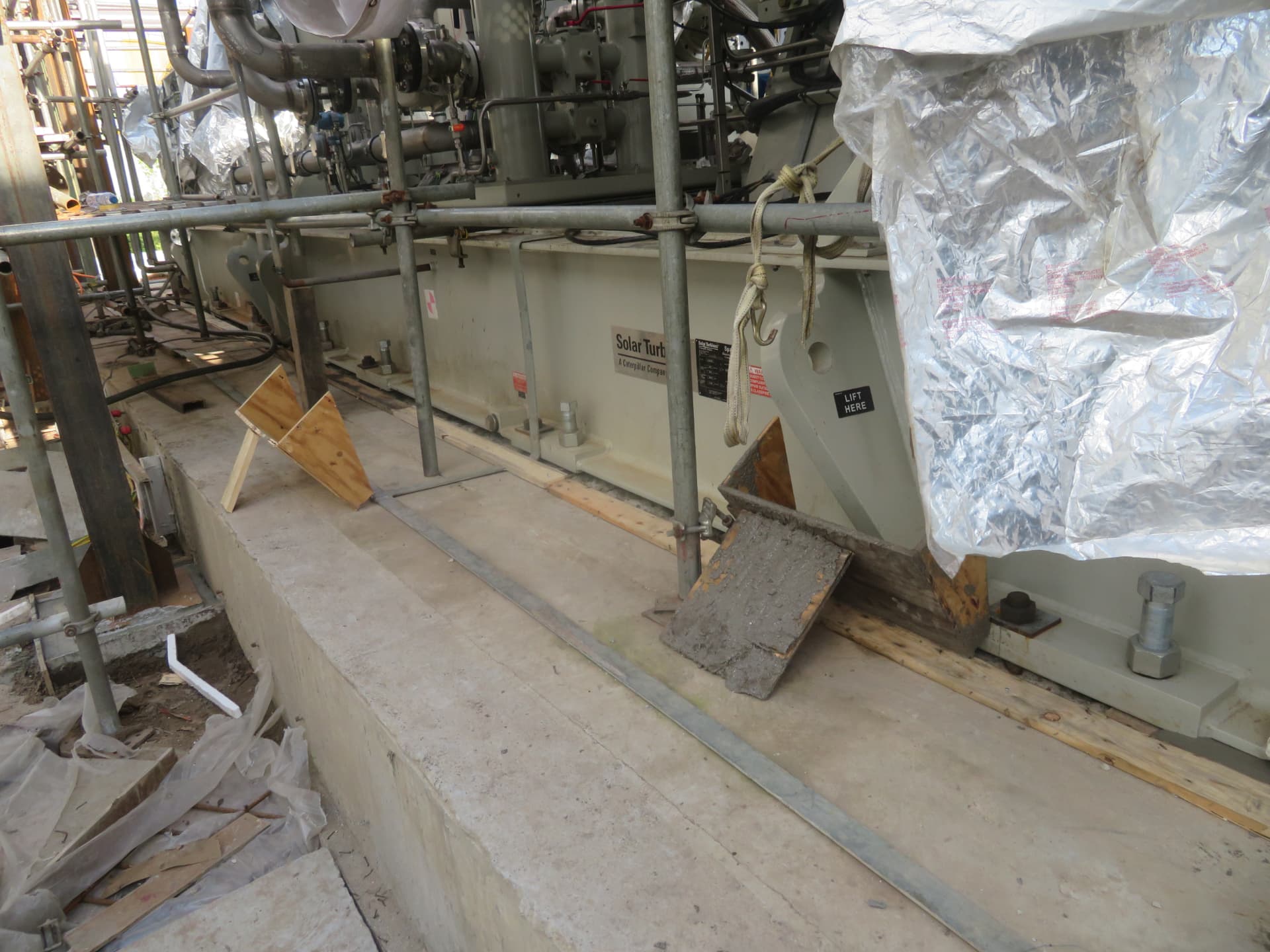 Compressor skid supported on levelling nuts before grouting