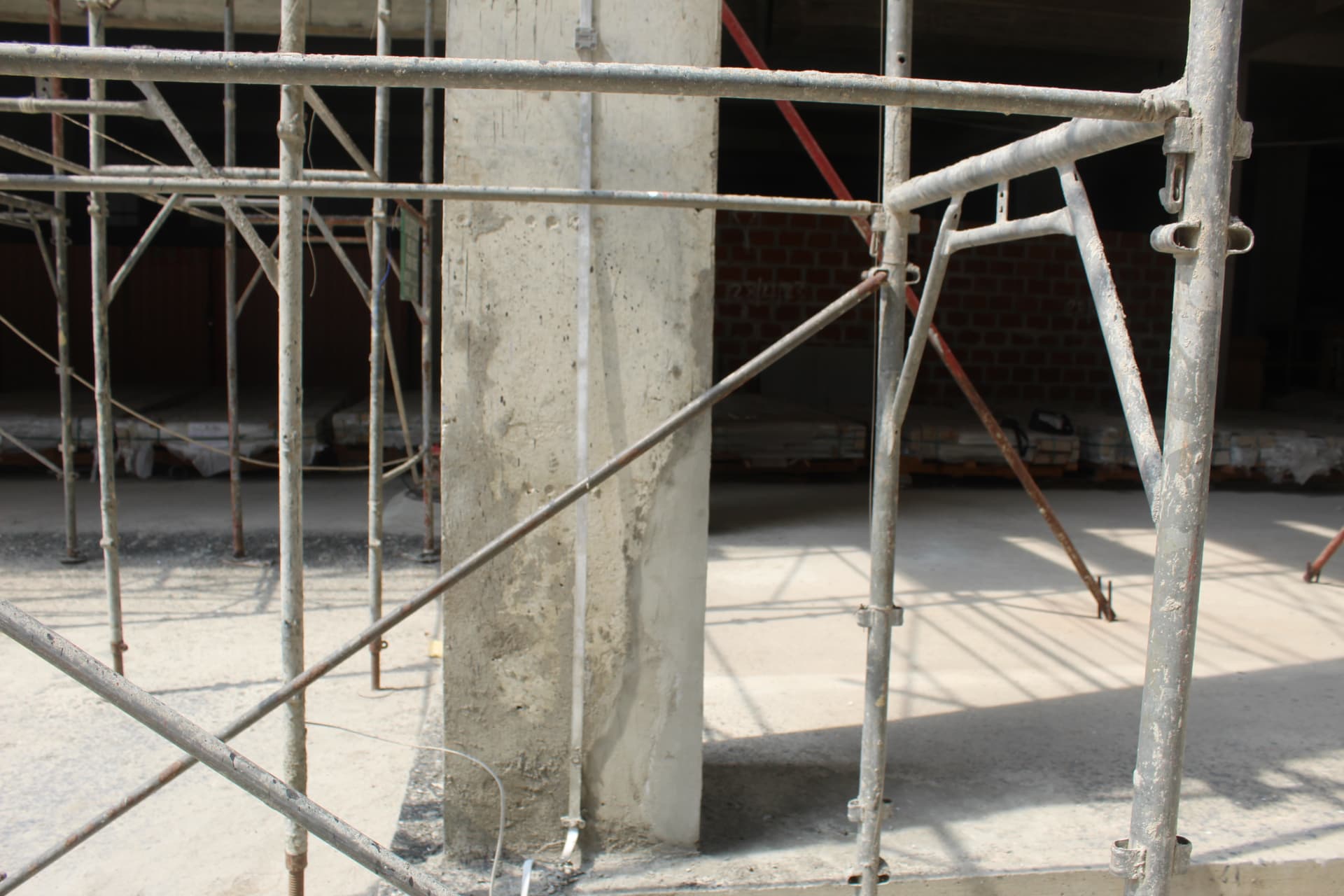 Prepared concrete column surrounded by access scaffolding
