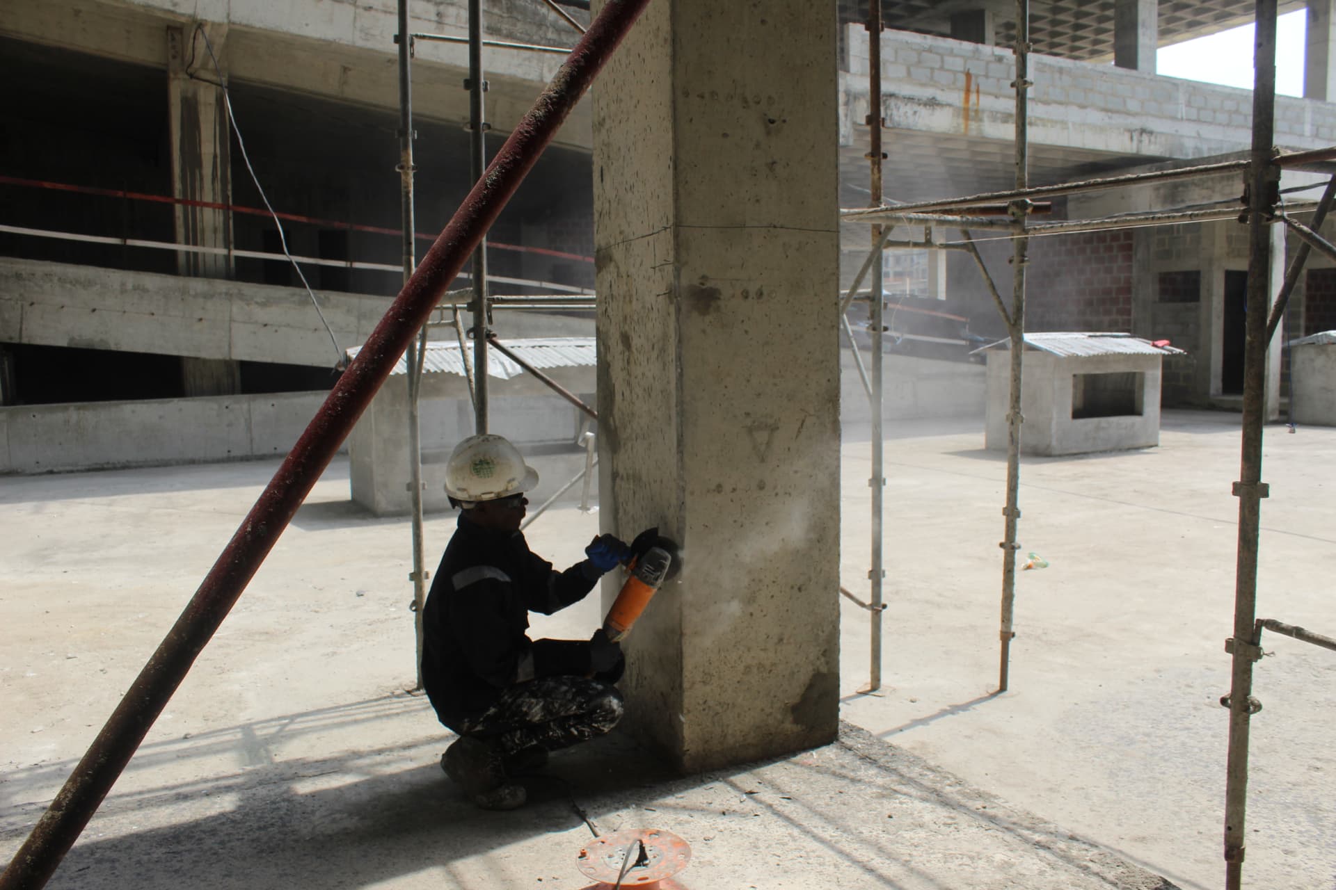 Technician preparing the base of a column within the scaffold bay