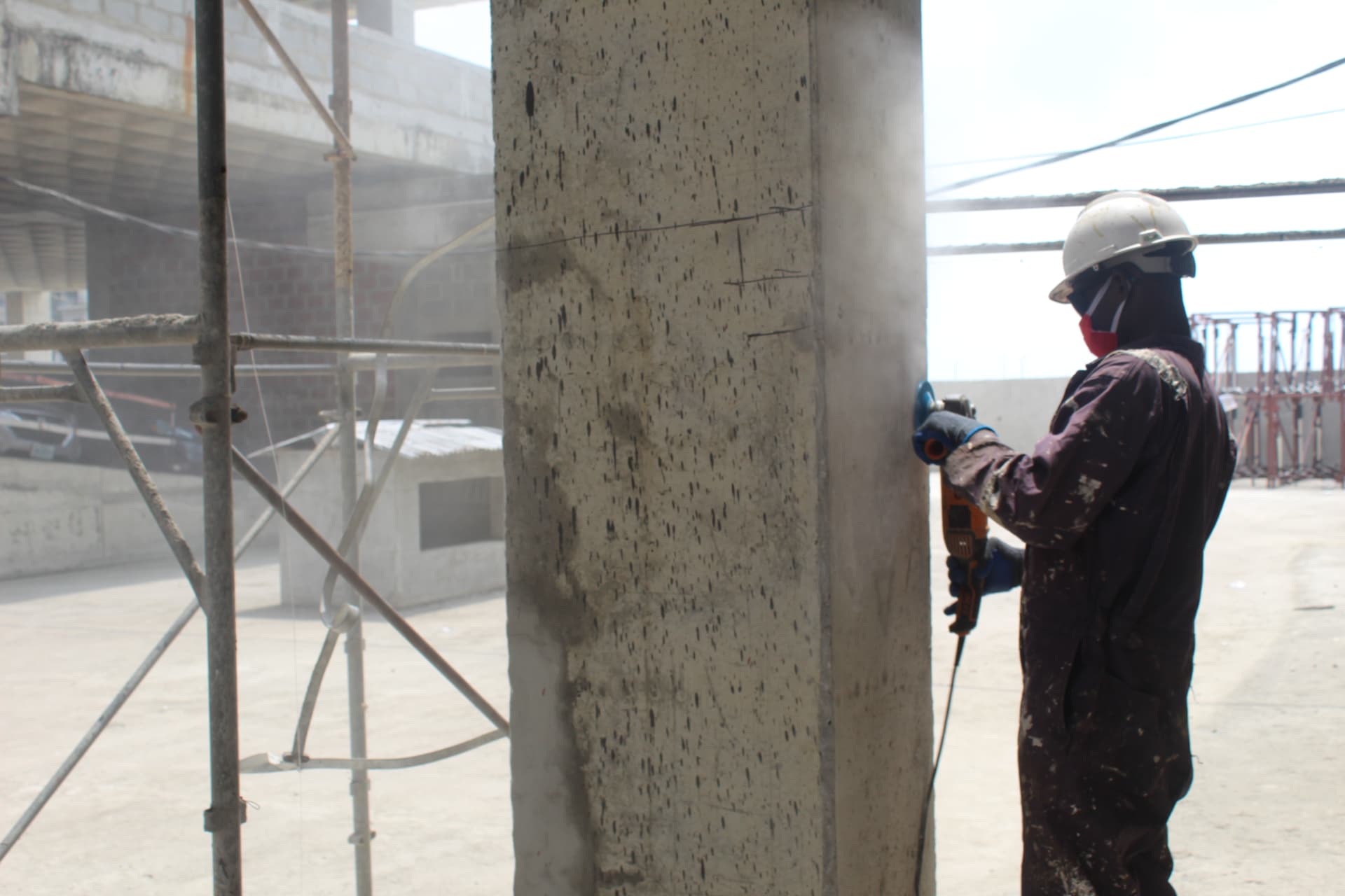 Surface preparation of a concrete column with a grinder