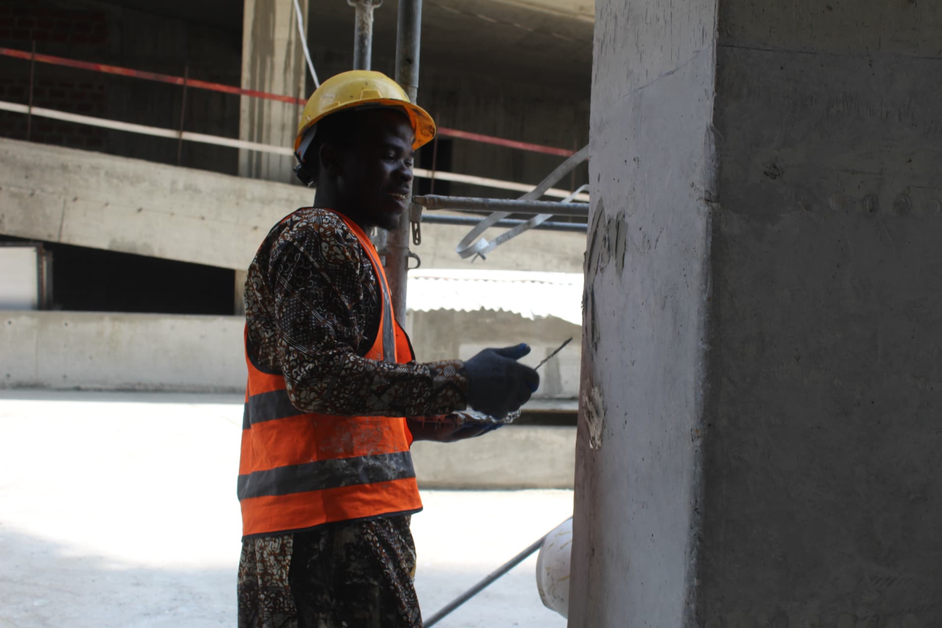 Operative applying epoxy putty to a prepared concrete column