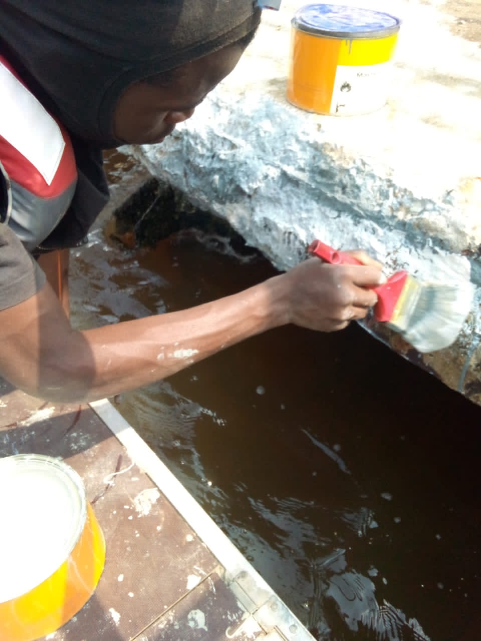 Brush application of protective coating to the jetty deck edge