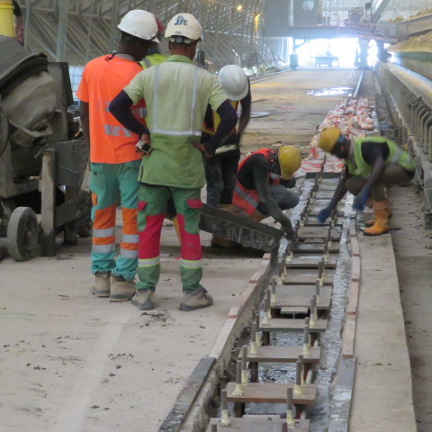 Crew placing grout into the formed rail pedestals