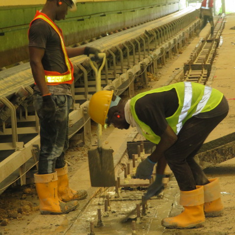 Crew placing grout to the reclaimer rail plinth line