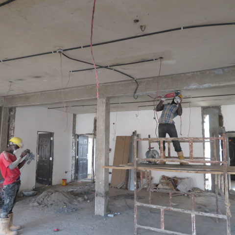 Team cutting a chase in the soffit for carbon laminate installation