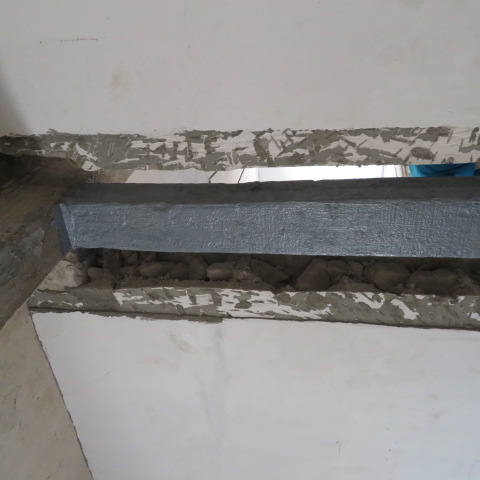 Exposed column and beam with reinforcement prepared for strengthening