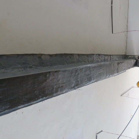 Underside view of a beam fully wrapped in carbon fibre fabric