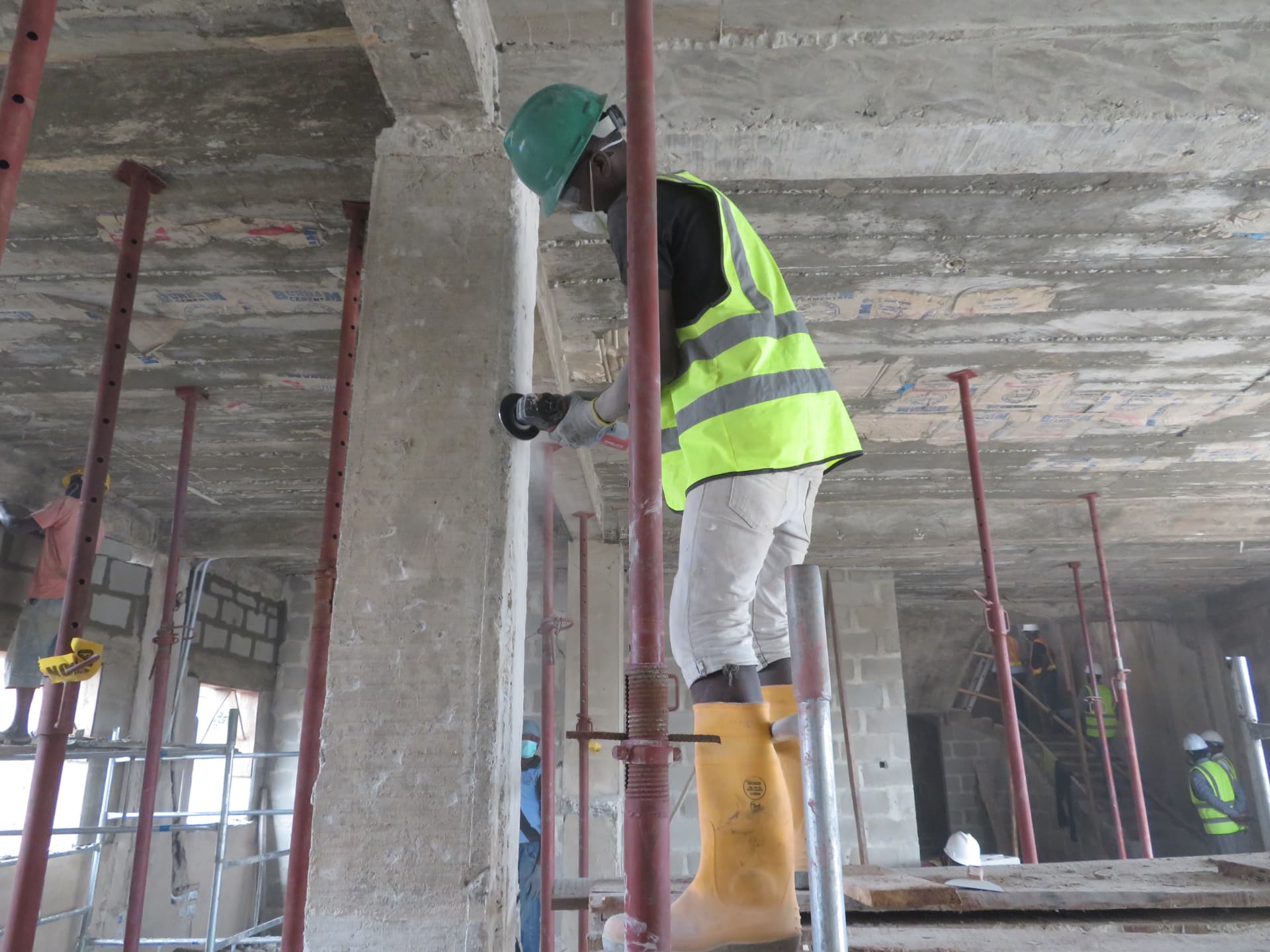 Engineer grinding a beam face in preparation for strengthening