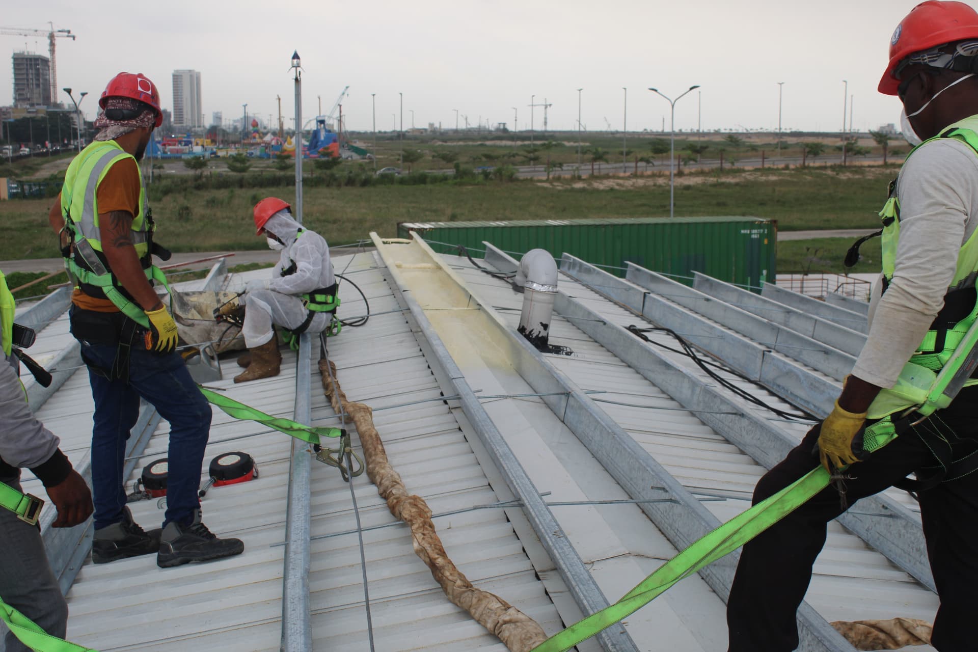 Crew in harnesses working across the roof during insulation works