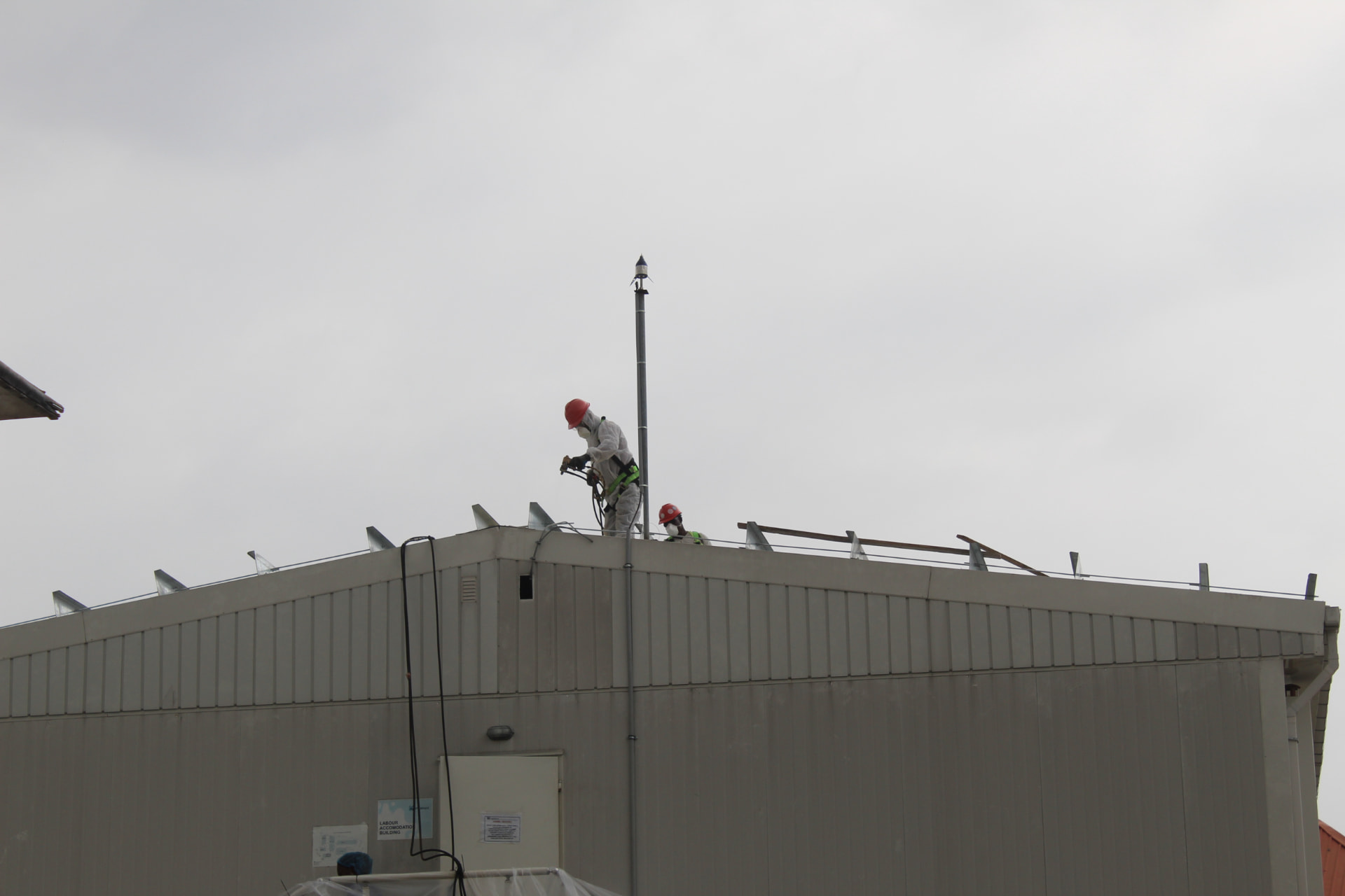 Spray foam application at the roof ridge seen from ground level