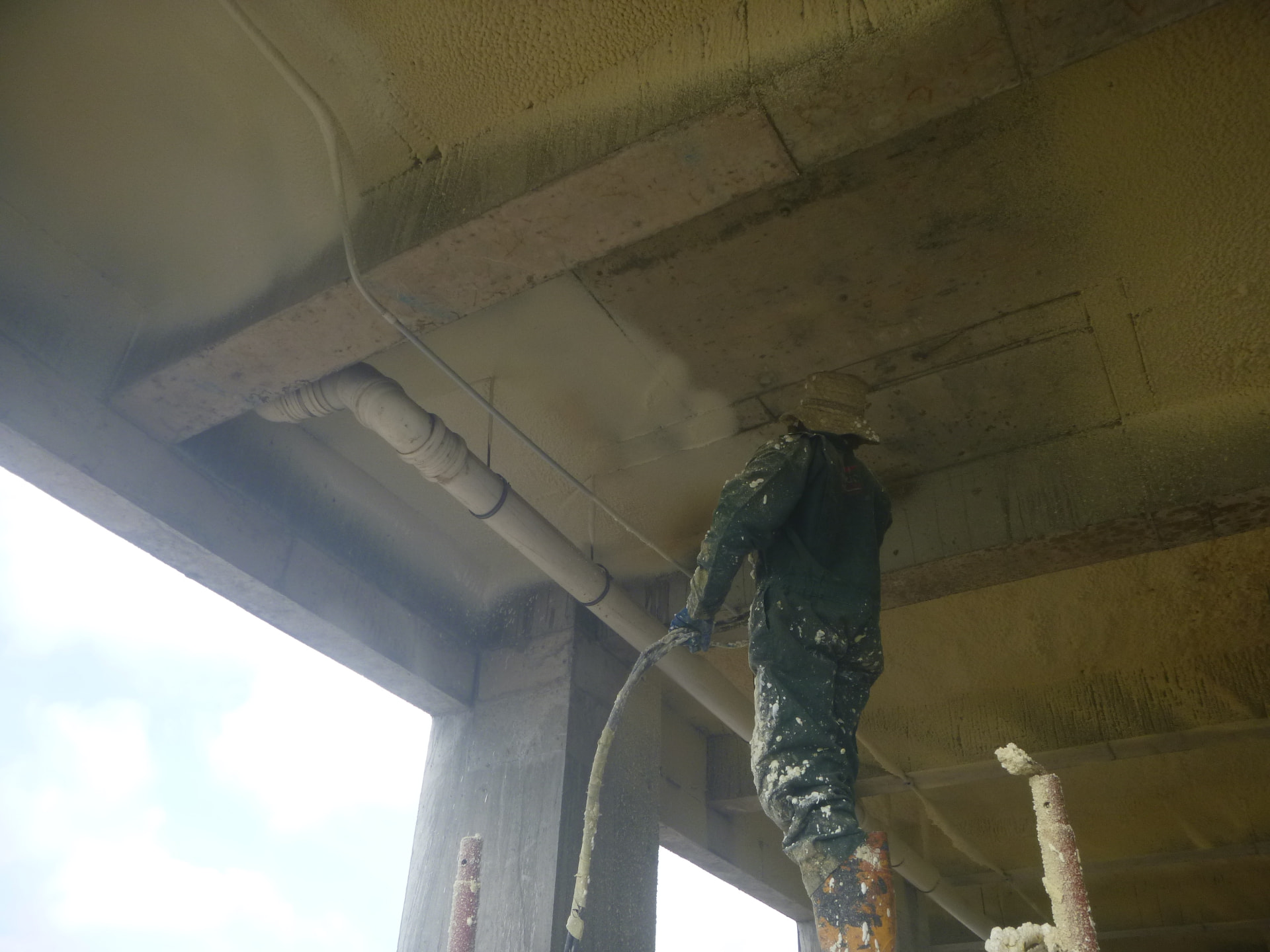 Operative spraying polyurethane foam to the underside of an external slab