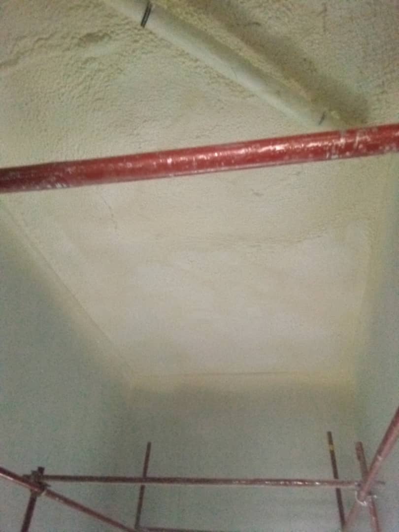 Smooth completed foam coverage to a ceiling bay seen from below